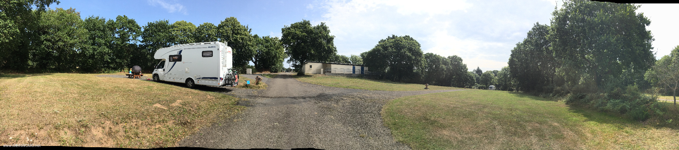  View of the pitches, a seating area and the sanitary building