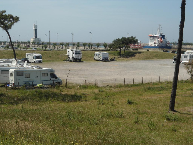  Seen place from the road, in the background a leaking cargo ship