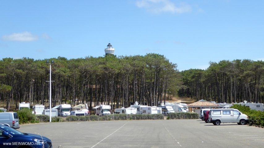 View of the parking space with the lighthouse in the background. 
