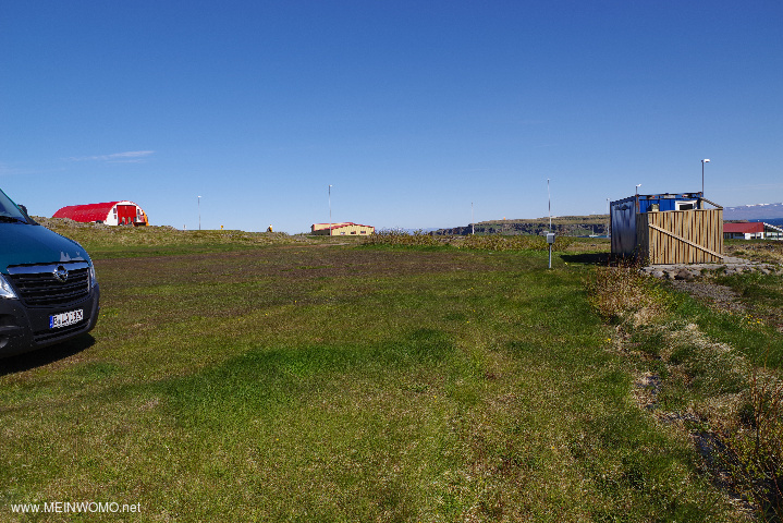  Part of the parking space meadow with sanitary building.