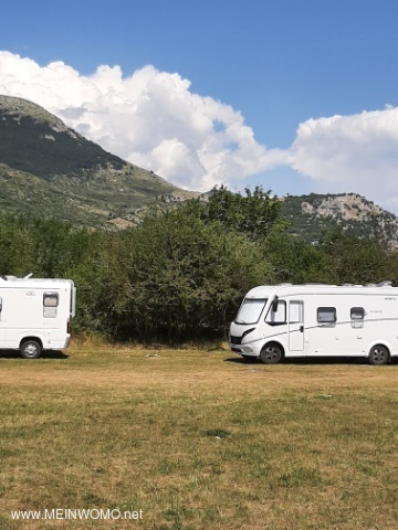 Motorhome parking spaces on a meadow a little above the lake